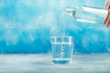 Pouring water from bottle into glass