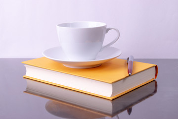 Education concept, World book day. Coffee cup, Pen and book on black table background with copy space for advertisers.