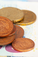 Micro loan offer. Little bit of European Union money. Metal coins of and paper banknotes design. Euro cash closeup on white background. Limited depth of field