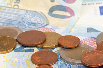 Micro loan offer. Little bit of European Union money. Metal coins of and paper banknotes design. Euro cash closeup on white background. Limited depth of field