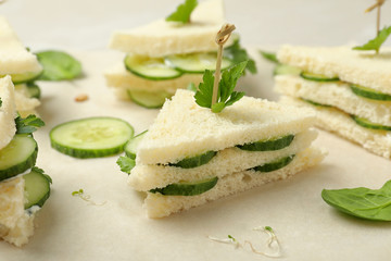 Traditional English cucumber sandwiches on parchment, closeup