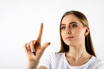 Young woman in white pushing the button