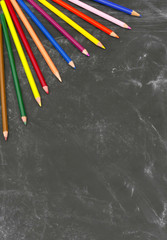 Portrait blackboard background with coloured pencils