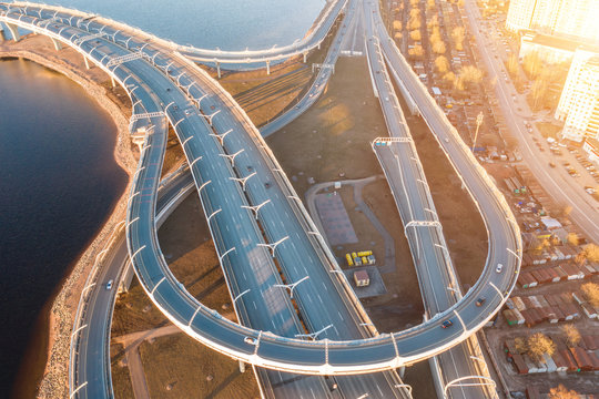 Aerial View Highway Loop Over A Road Junction In The Evening At Sunset.