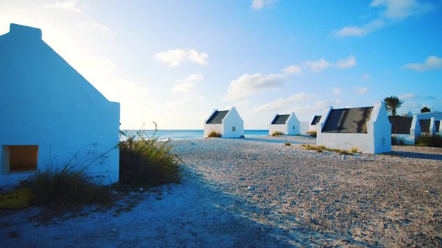 Slow motion parallax shot of the white slave huts in Bonaire, Caribbean, at sunset