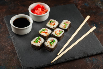 Japanese sushi on a rustic dark background.