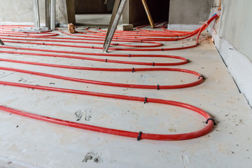 Tubes of the underfloor heating system on a styrofoam insulation