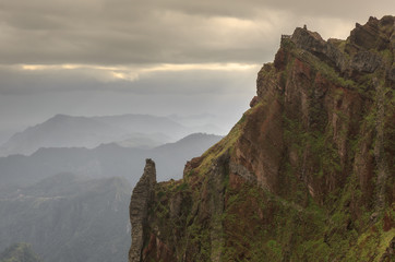 Beautiful panorama view of the landscape in the mountains of Madeira at Pico do Areeiro (Arieiro) while hiking to Pico Ruivo on a cloudy summer day with the buzzards nest viewpoint