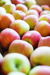 Fresh harvest of apples on the counter flooded with sunlight. Vegetables and fruits in the market