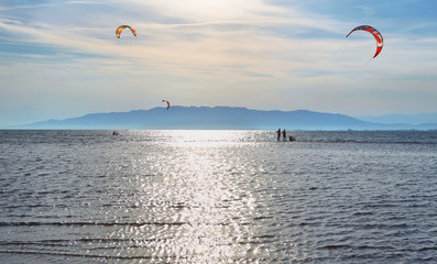 Unidentified people practising kite surf in Ebro Delta, Spain