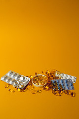 medicines spilled on a yellow background