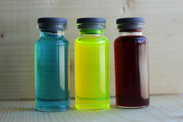 Aqueous solutions of colored dyes in glass jars.