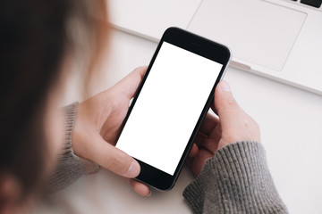 Close up Woman hand Using a Smart Phone with blank screen at home.