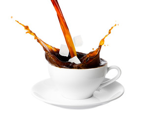 Pouring coffee and sugar cube into cup with splashing isolated on white background.
