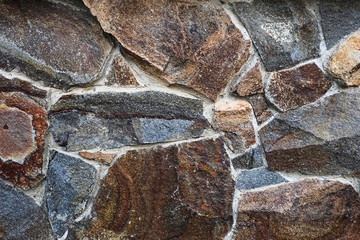 Wall texture paved with stone material. Rock texture close-up