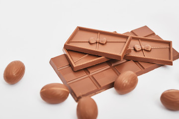 Delicious chocolate Easter bunny and eggs on white background top view copy space. Easter Greeting Card Template. Happy easter concept. Chocolate on white background. Chocolate Bars and Easter Sweets