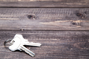 House keys on brown wooden table