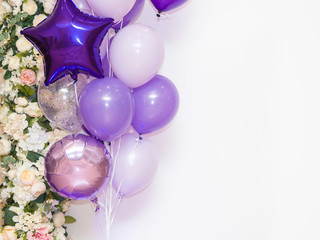Star shaped balloons and round purple balloons on a white background.