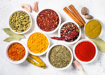 Colored indian spices on white table.
