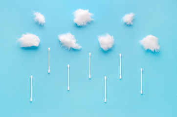 cotton wool clouds and swabs rain on blue background