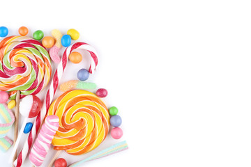 Sweet candies and lollipops on white background