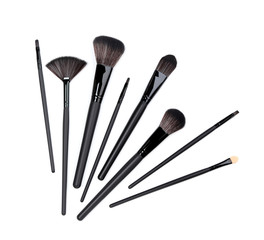 Black makeup brushes isolated on white background