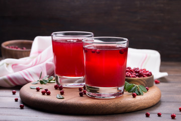 Fresh cranberry drink on wooden background. Still life