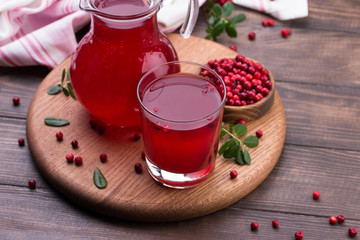 Fresh cranberry drink on wooden background. Still life