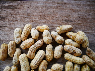 peanuts in shell on wood background