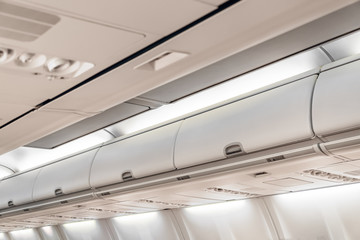 Closed doors luggage shelves in economy class passenger aircraft.