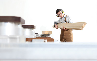carpenter man works with wooden planks in the joinery, with computer numerical control center, cnc...