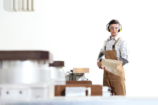 carpenter man works with wooden planks in the joinery, with computer numerical control center, cnc machine,  isolated on a white background
