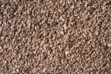 Grunge texture of crushed stone, cracked concrete and old asphalt