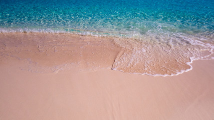 Fototapeta na wymiar Waves from the Atlantic Ocean during a warm sunny day at the beach. Nassau, the Bahamas.