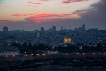 Naklejka na ściany i meble Beautiful aerial view of the Old City, Dome of the Rock and Tomb of the Prophets during a dramatic sunset. Taken in Jerusalem, Capital of Israel.