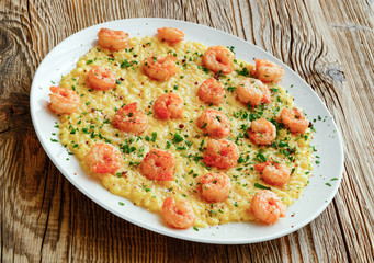 fried shrimps with saffron risotto decorated with parmesan, parsley and pink pepper 