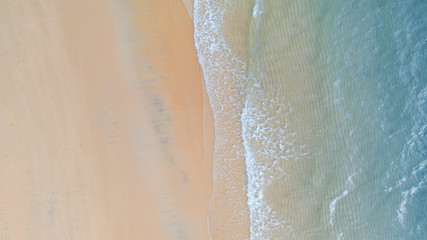 Aerial view of Beach with shade emerald blue water and wave foam on tropical sea