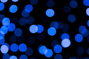 Unfocused abstract colourful bokeh black background. defocused and blurred many round blue light