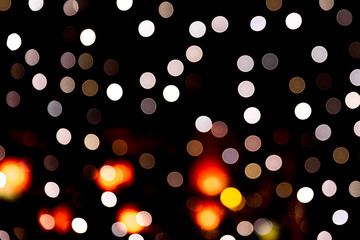 Unfocused abstract colourful bokeh on black background. defocused and blurred many round light