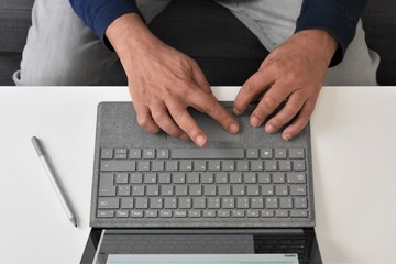 Fototapeta na wymiar Male hands typing on a laptop