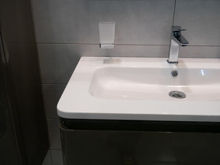 moder washbasin at hotel room in dim light