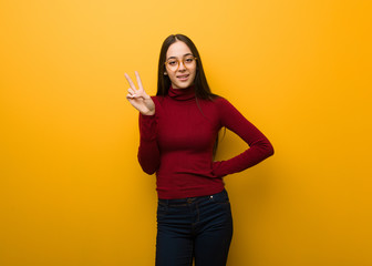 Intellectual young girl doing a gesture of victory