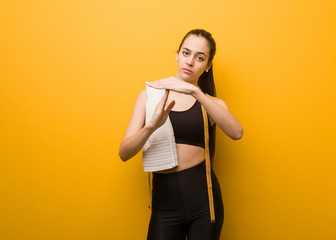 Young fitness girl doing a timeout gesture