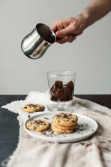 Glass of cold brew with hot milk and Homemade chocolate chip cookies