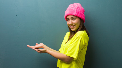 Young modern woman holding something with hands