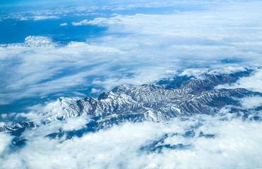 mountain range in the clouds, view from an airplane