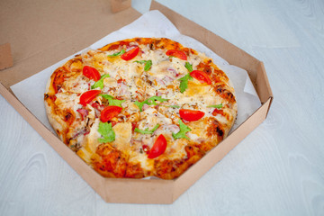 Pizza in a cardboard box . Space for text. View from above. Pizza delivery.