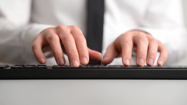 Wide view image of programmer using computer keyboard