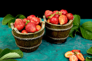 Strawberry in the bowl on a green background.