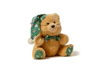 Toy bear in hat on white background.